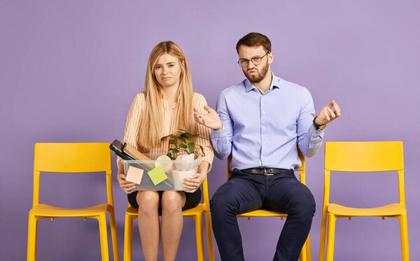 blonde woman and man embarrassed by unpleasant surprise