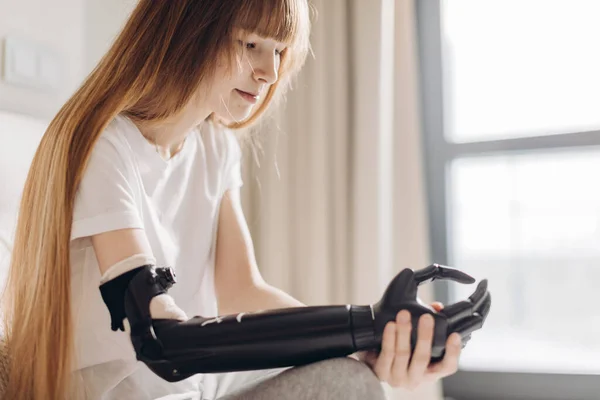 Pensive serious girl having a cyber arm — Stock Photo, Image