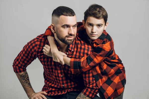 Pleasant boy on the shoulders of his father — Stock Photo, Image