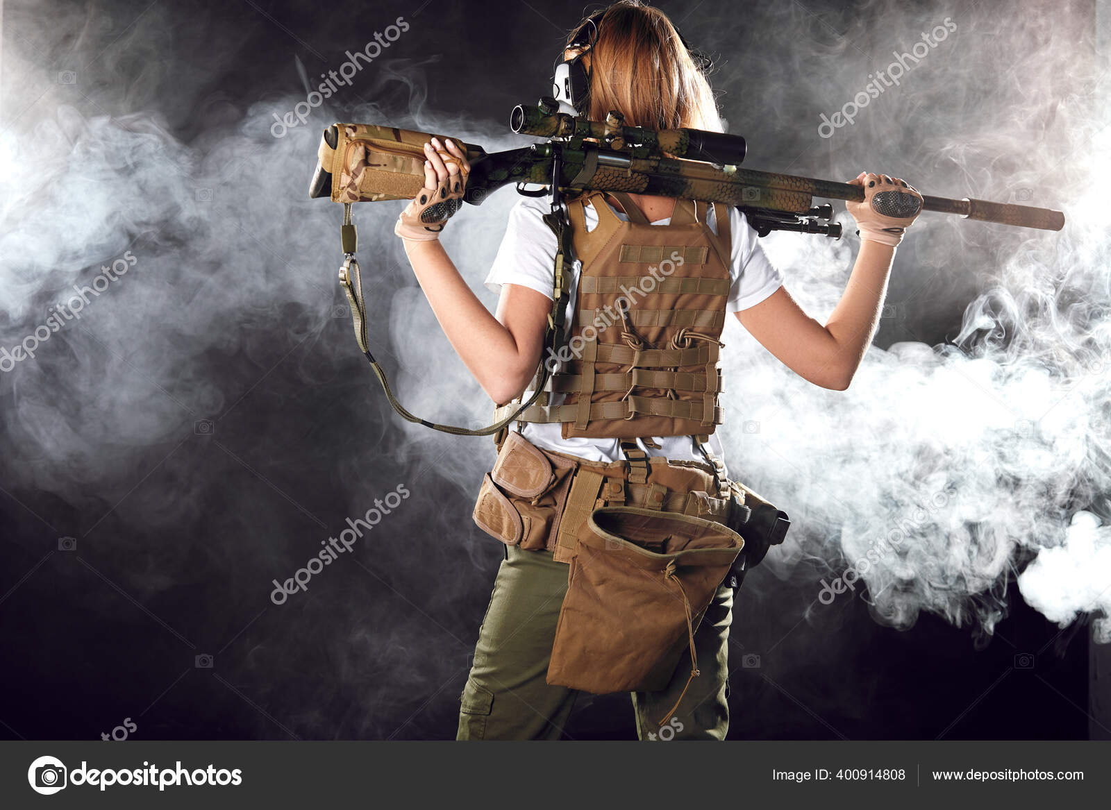 Airsoft female shooter holding an automatic assault rifle and aiming at  enemy. Stock Photo by ©ufabizphoto 400914808