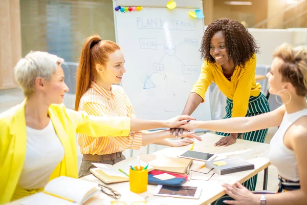 Happy awesome businesspeople putting their hands on top of each other — Stock Photo, Image