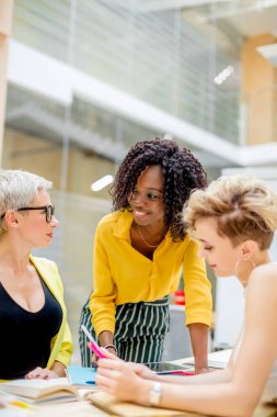 Müşterilerle çalışmak için etkili iletişim becerileri geliştiren mutlu genç kadınlar