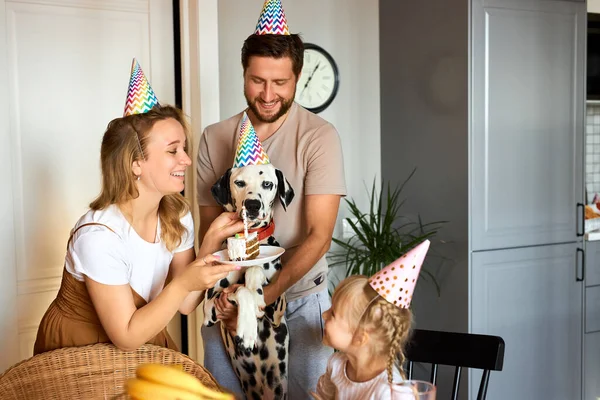 young family with daughter celebrate pets birthday