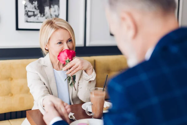 Kärleksfull vacker kvinna i snygg kostym tacka han make för en blomma — Stockfoto
