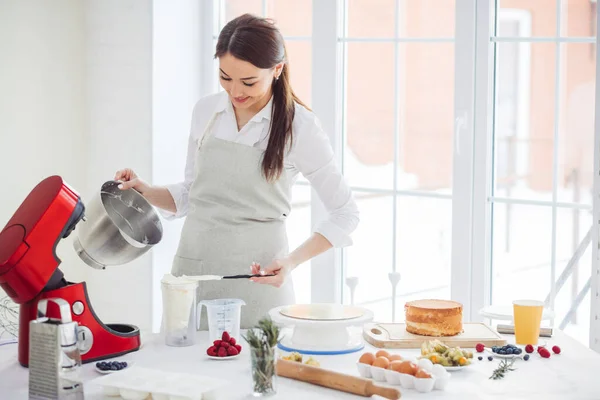 Cheerful pouring the cream in the glass — Stock Photo, Image