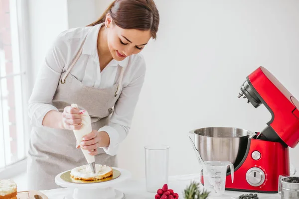 Pleasant gorgeous woman gets pleasure from cooking cake — Stock Photo, Image