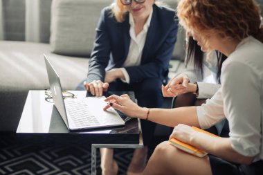 Farklı saç stiline sahip üç odaklı iş kadını ofiste birlikte çalışıyor..