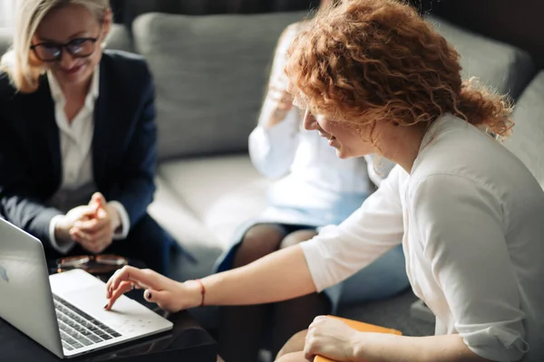 Group of young female marketing trainees share ideas with each other