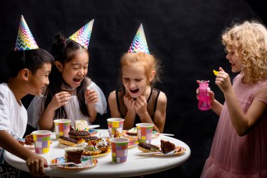 Komik gülen çocuklar patlamış baloncuklara bakıyorlar.