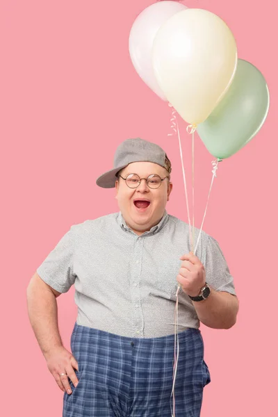 Happy emotional man in his 30s is overjoyed about his joke with air balloons. — Stock Photo, Image