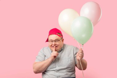 Funny man much similar to Winnie the Pooh with air baloons isolated over pink clipart