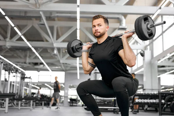 Kaukasischer athletischer Mann, der mit Langhanteln Muskeln aufpumpt — Stockfoto