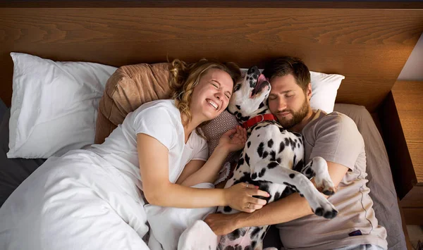 beautiful family spend weekends with dog in cozy home environment