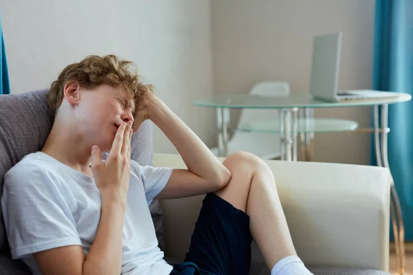 Sleepy teenager boy sit alone at home — Stock Photo, Image