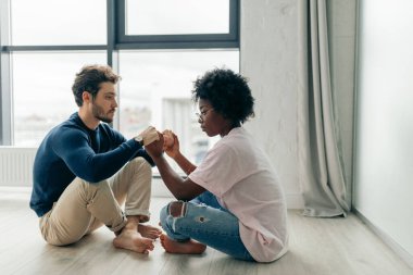 Karışık ırk yoga çalışmalarının kapalı çekimleri, ahşap zeminde poz vermeleri..
