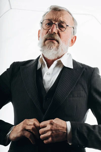 Stylish elderly business man adjusting formal black suit, prepares to meeting. — Stock Photo, Image