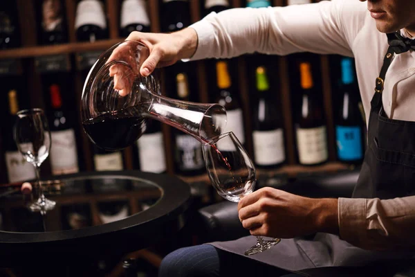 Wine taster or degustator pouring red wine into carafe to make perfect color — Stock Photo, Image