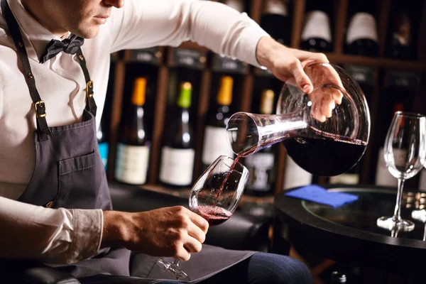 Expert decanting and pouring wine into glass. Staff training for sommelier — Stock Photo, Image