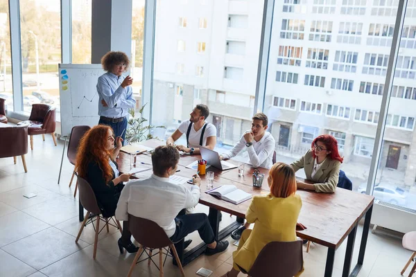 Young leader male giving speech to young business co-workers — Stock Photo, Image