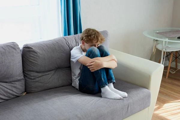 Sad child boy sit crying alone at home — Stock Photo, Image