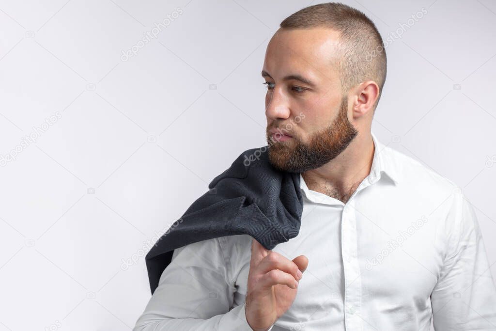 Handsome manful businessman holding his jacket over shoulder on white background