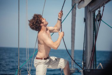 Burun yatında duran genç sakallı adamın alçak açılı görüntüsü.