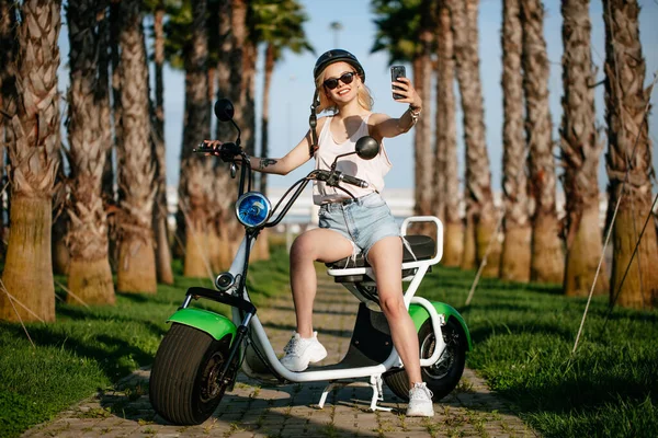 Mulheres com cidade moderna elétrica e-bike limpo transporte urbano sustentável — Fotografia de Stock