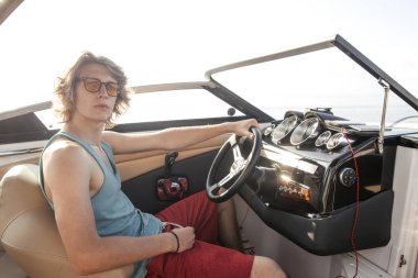 Gülümseyen genç denizci Karayip denizinde yol alıyor.