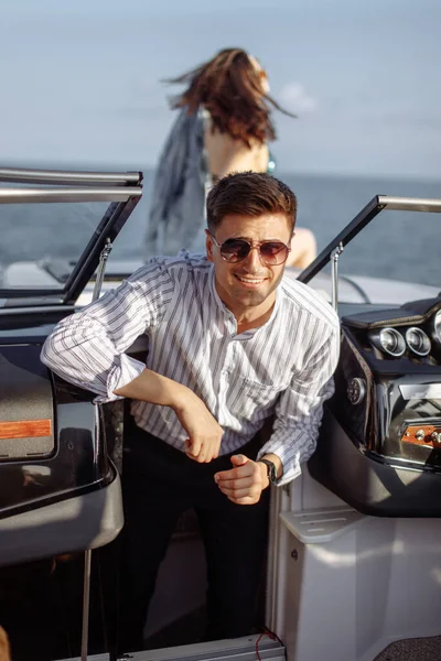 Young married couple having sea excursion on motor boat — Stock Photo, Image