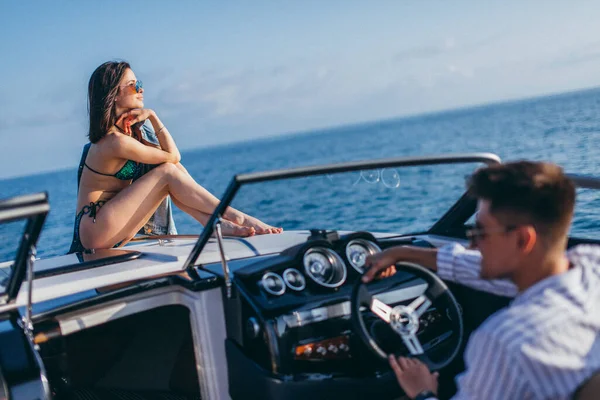 Young married couple having sea excursion on motor boat — Stock Photo, Image