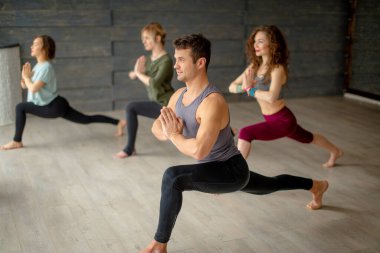 Esneklik egzersizi yapan gençler, vücut dengesi sınıfı, yoga pratiği.