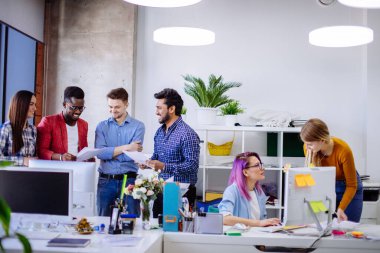 Modern ofisteki gençler yeni bir proje üzerinde tartışıyorlar.