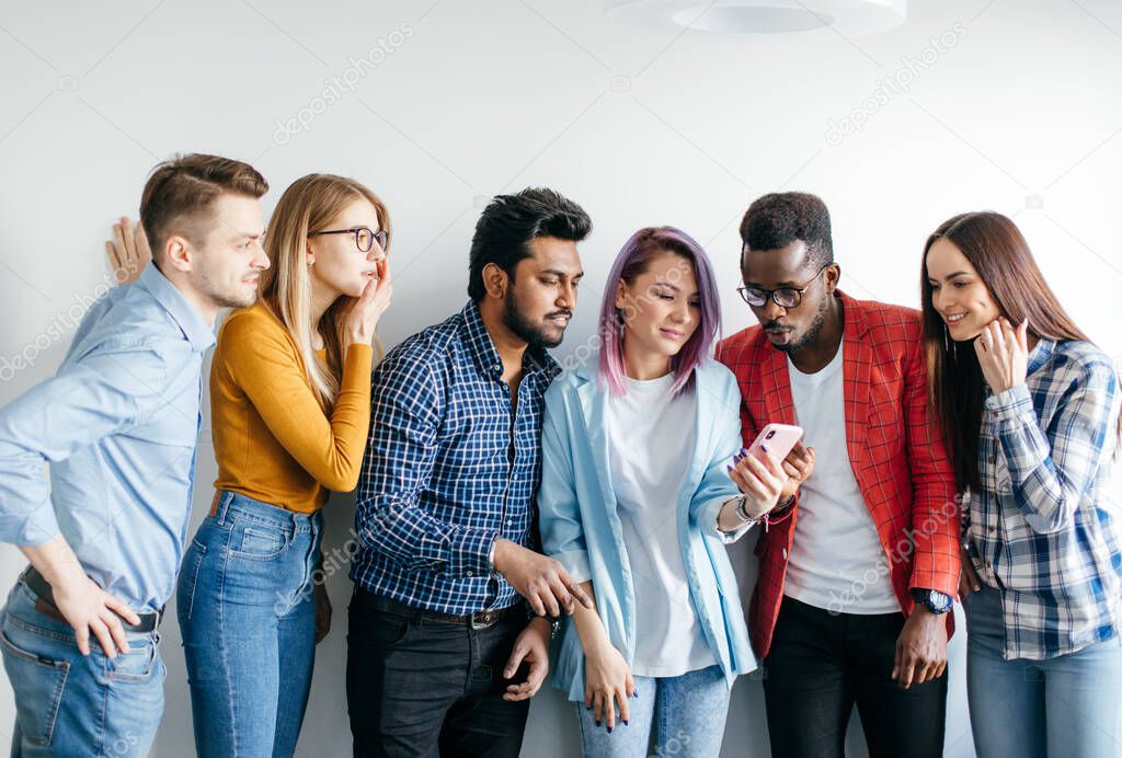 Multiethnic Group of Young People in Casual Wear isolated over grey background
