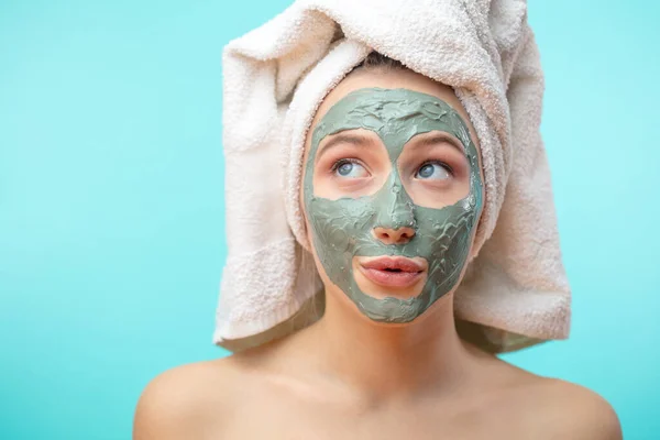 The girl in a mask for the face with a towel on his head — Stock Photo, Image
