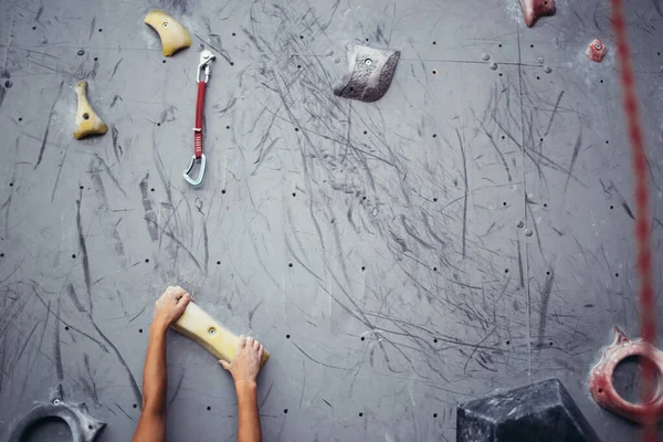 Female climber hands holding artificial boulder in climbing gym, closeup shot — Stock Photo, Image