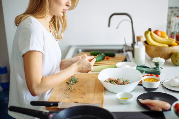 Pleasant young woman preparing dinner in a kitchen concept cooking, culinary — Stock Photo, Image