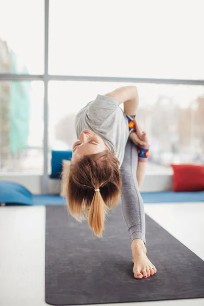 Woman practicing yoga , Triangle pose in fitness center — Stock Photo, Image