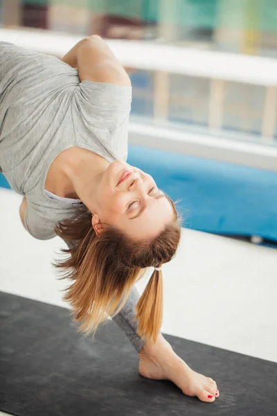 Woman practicing yoga , Triangle pose in fitness center — Stock Photo, Image