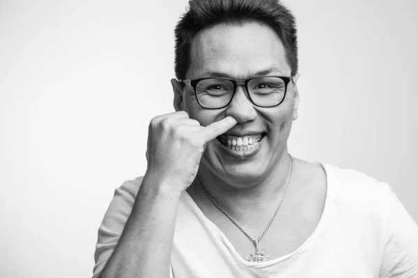 Happy funny Asian man in his 30s in white usual t-shirt with different positive emotions — Stock Photo, Image