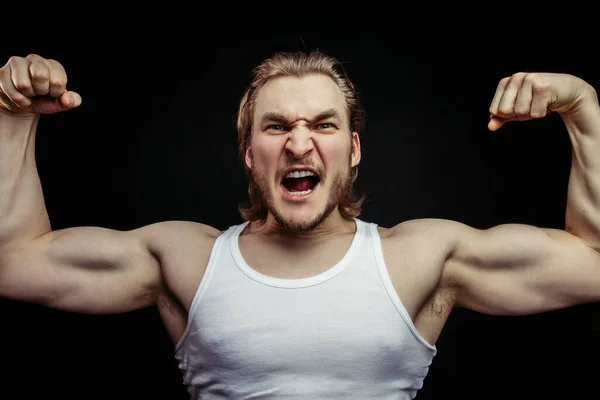 Angry jock showing his musculars — Stock Photo, Image
