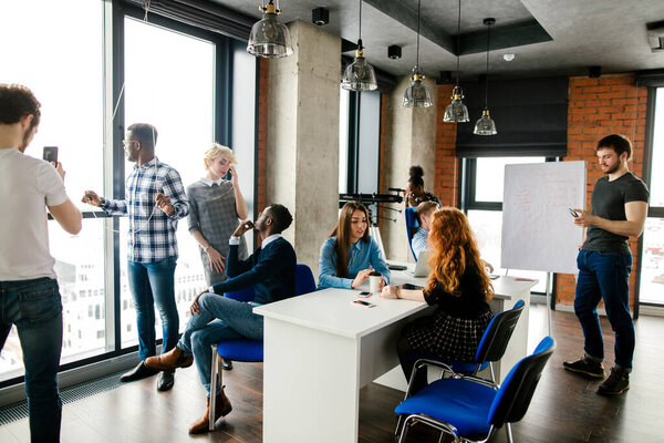 young multi-ethnic people are waisting their time in the room