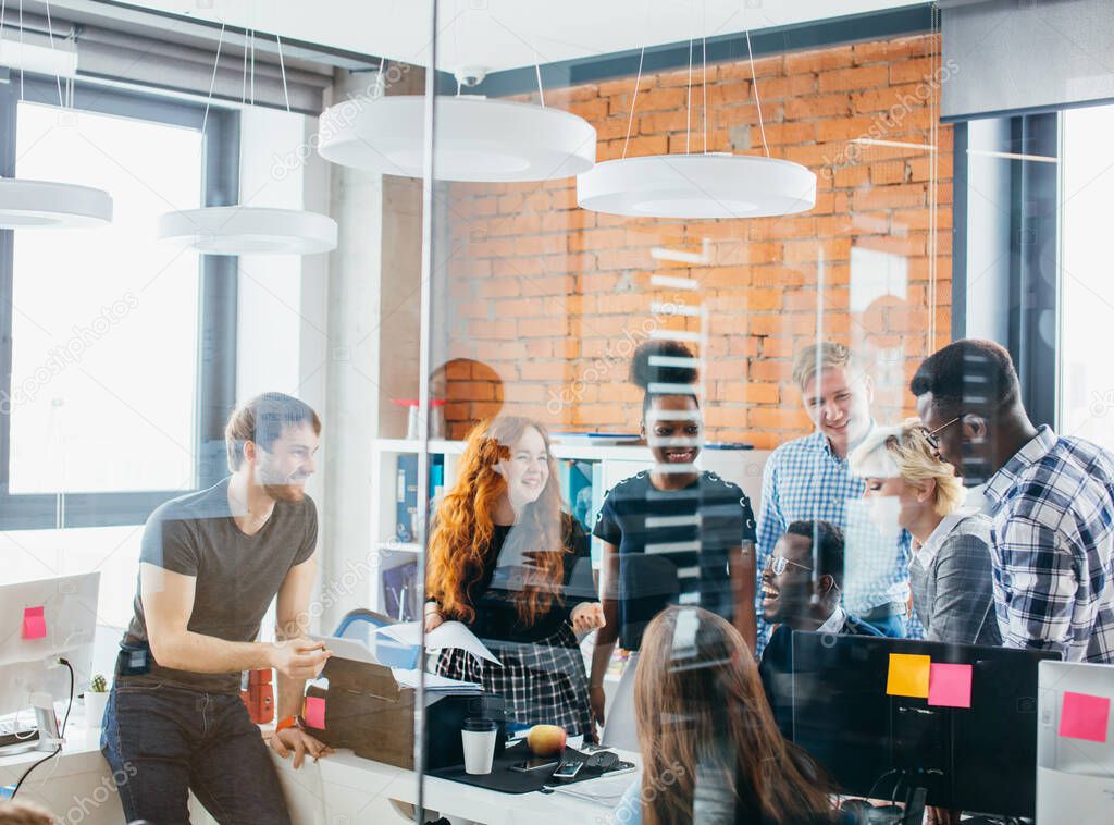 friendly multy ethnic group of collegues greeting new worker