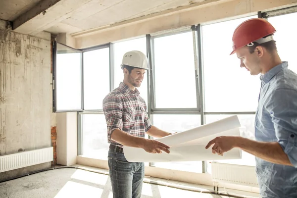 Talentoso engenheiro está entregando um plano de construção — Fotografia de Stock