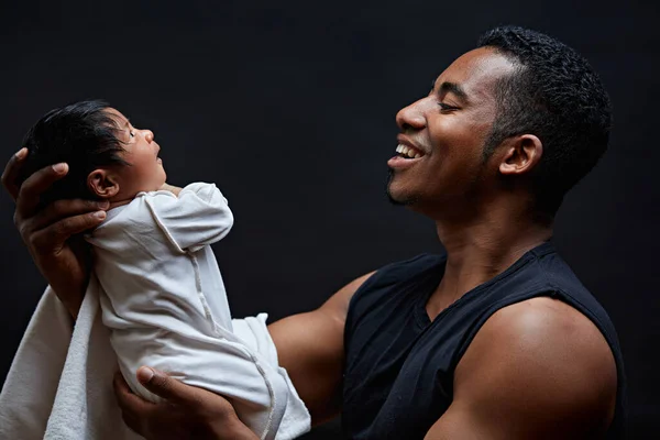 fatherly love. close up side view portrait of a happy man with his baby