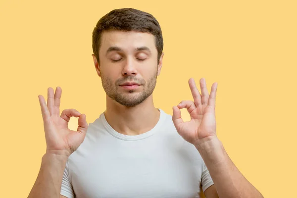 Man with closed eyes gesturing OK sign — Stock Photo, Image