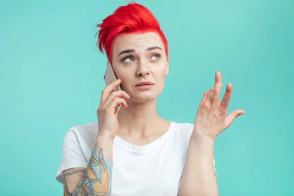 Young attractive female using gestures during talking on the phone — Stock Photo, Image