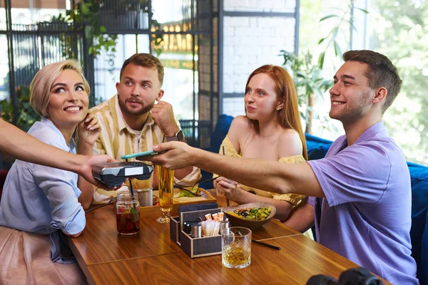 affable waitress give customers card terminal