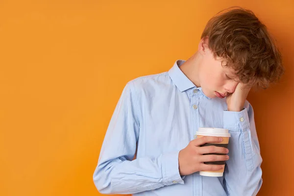 Portrait of sleepy teenager boy with cup of coffee — Stock Photo, Image