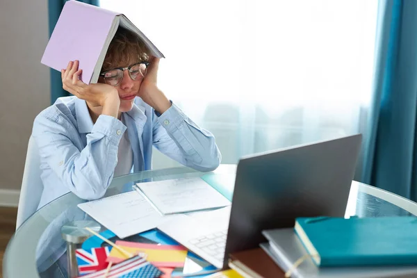 Schoolboy studying at home looking at tutor at laptop screen during quarantine isolation period — Stock Photo, Image