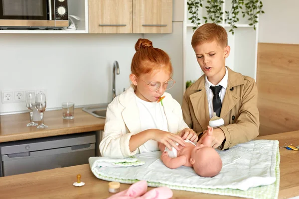 Padres jóvenes, los niños cuidan del bebé — Foto de Stock